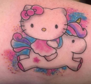 Color Hello Kitty riding a unicorn tattoo