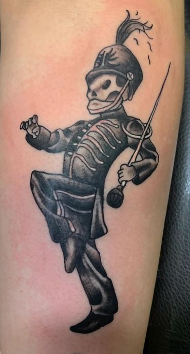 Black and grey skeleton marching band tattoo