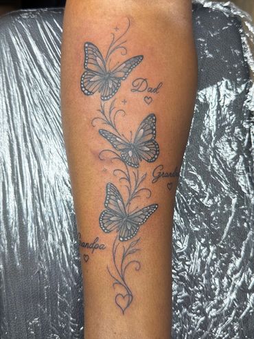 Fine line butterfly memorial tattoo with lettering