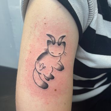 Black and grey horned cat Capricorn tattoo by Eva