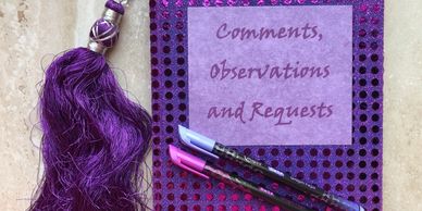 Purple sequin fabric notebook with plum and purple pen and purple silk tassel. 