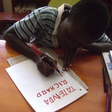 boy writing on paper