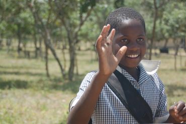 girl in school uniform waving