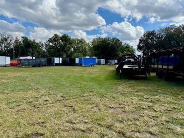 Freshly mowed commercial equipment yard with trailers around the property.