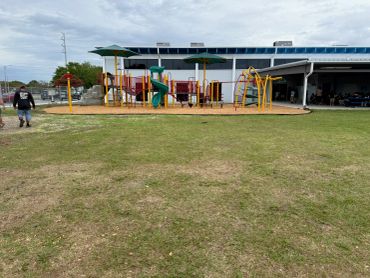 Maintained commercial lawn surrounding a community playground.