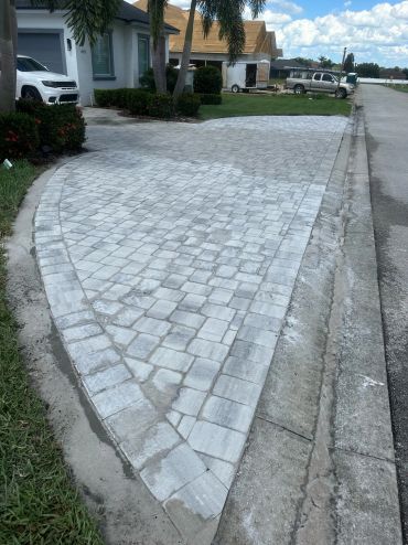 Newly installed paver driveway with a clean transition to the roadway.