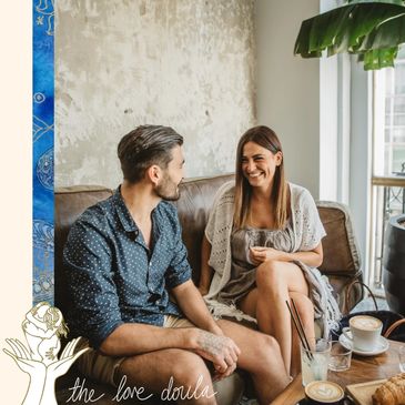 Young attractive brunette couple sits at coffee shop cafe connecting for their first date