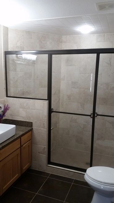 Sliding shower door and in-line panel