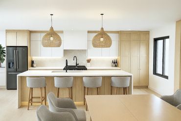 Modern kitchen with light wood finishes and wicker pendant lights.
