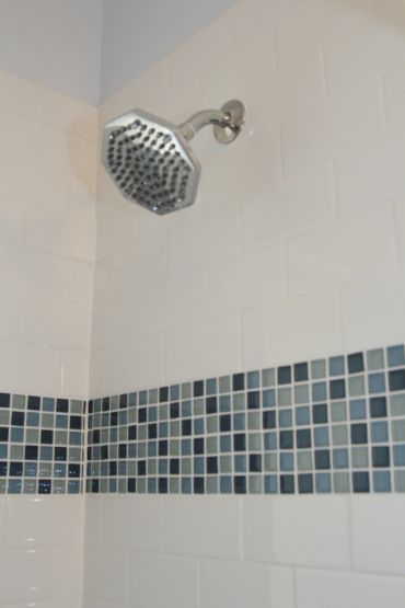 Shower with accent tile and traditional subway tile