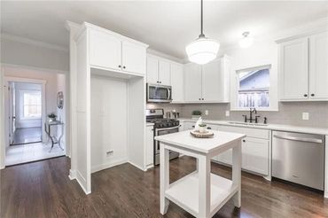 Custom kitchen remodel. Custom cabinetry, subway tile, Carrera marble tops, hardwood floors