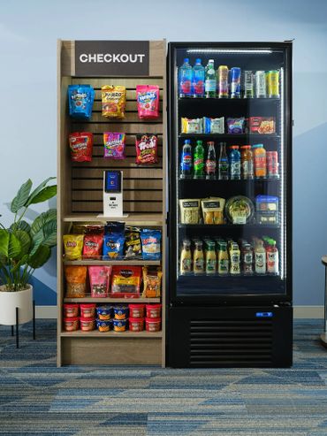 A self-checkout snack and drink station with chips, candy, and beverages.