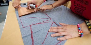 people tracing the material by hand