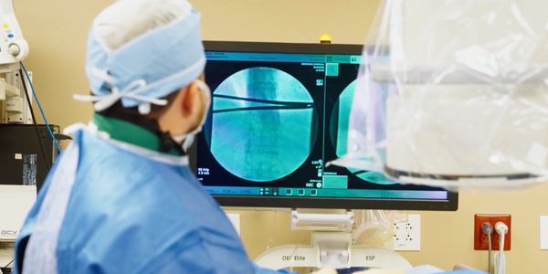 Surgeon viewing medical imaging on a monitor.