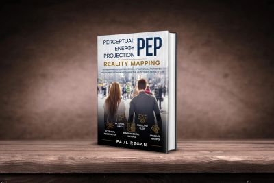 Book titled 'Perceptual Energy Projection (PEP) Reality Mapping' by Paul Regan on a wooden surface.