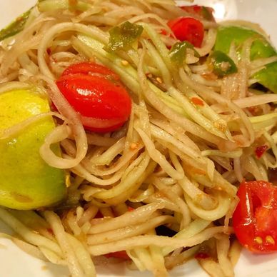 Shredded green papaya with lime juice and tomatoes.