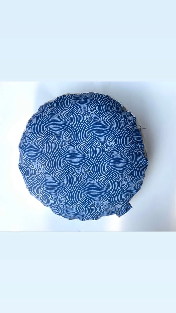 round pillow in blue and white pattern