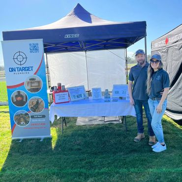 On Target Plumbing owners at expo. Discussing whole home water filtration systems