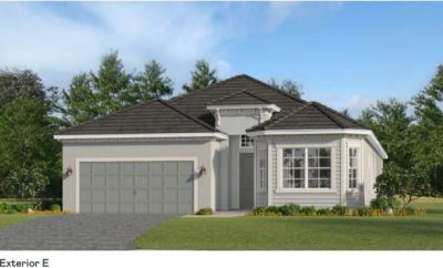 Single-story modern house with a two-car garage and a well-kept lawn.