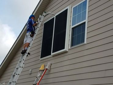 Window impact screen installed over window.
Bahama shade and screen