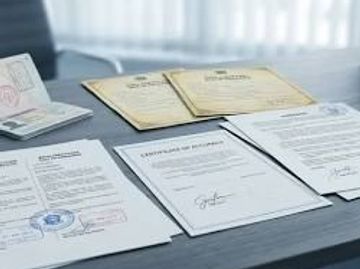Official documents and certificates on a desk.