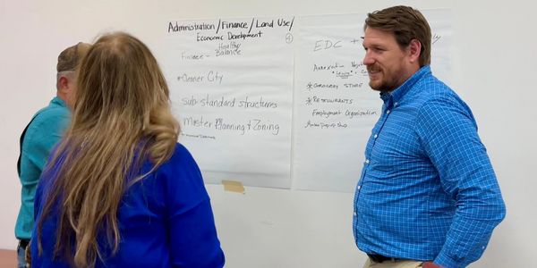 People discussing urban planning topics in a meeting room.