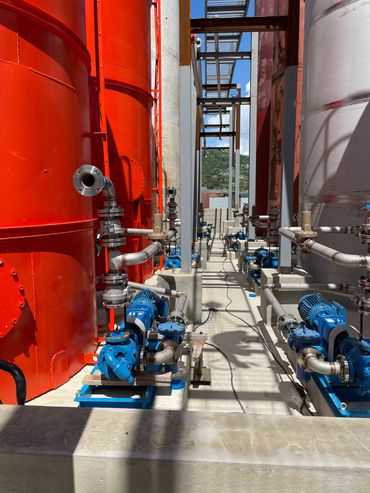 Industrial pipes and pumps in a facility.