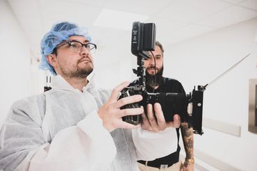 Video Aces Video camera operator in scrubs filming in a New Orleans hospital
