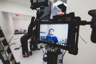 Camera monitor showing an interview being filmed in a New Orleans clinic