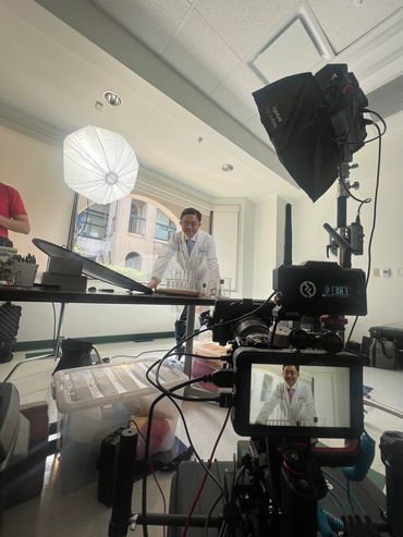 Lit interview setup with softboxes and a camera monitor in a New Orleans office