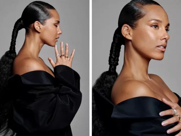 Elegant woman with a sleek braided ponytail and off-shoulder black outfit.