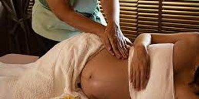 Pregnant woman on massage table enjoying a relaxing massage.
