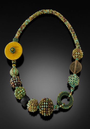 Necklace of handwoven and layered glass beads.