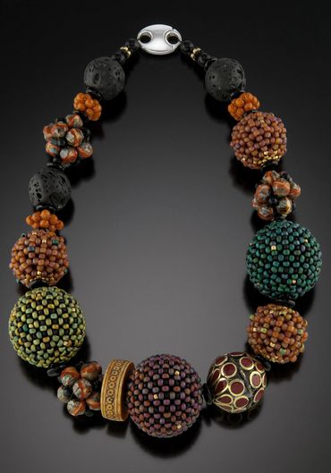 Necklace of handwoven and layered glass beads