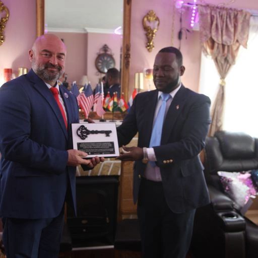 Chautauqua County Executive PJ Wendel receives the key to Sustainability from Ambassador Hugues Sano