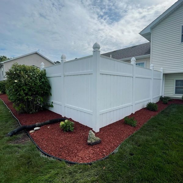 A white fence in front of a house