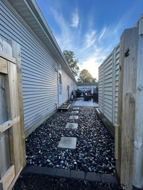 A house with a gravel path between two buildings