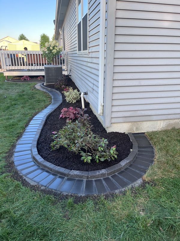 A house with a flower bed in the front yard