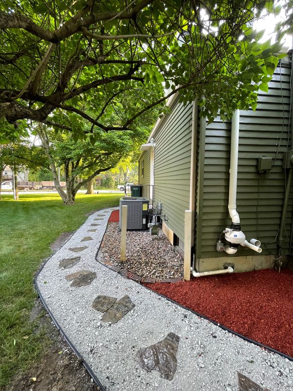 A green house with a red pathway leading to it