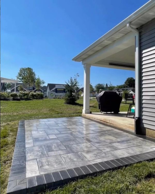 A patio that has a grill on it