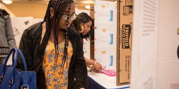 Young inventor reviewing invention.