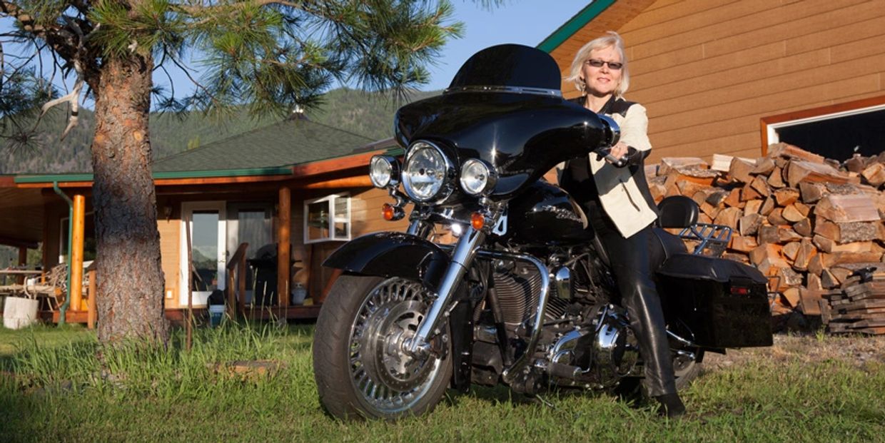 Lana on a motorcycle on her property in Thompson Falls Montana.