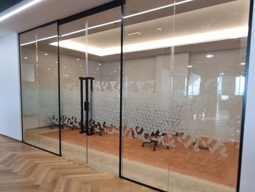 Modern office renovation with bespoke joinery, glass partitions, and functional workspace design.