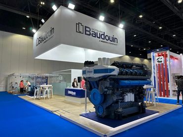 indoor exhibition stand in Dubai for Baudouin – bold design showcasing large industrial machines.