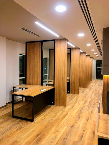 Corporate office interior design in Dubai with wood ergonomic furniture and wood partition and table