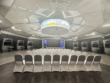 event tent interior in Dubai with stage, big LED screen, and seating setup for innovation showcase.