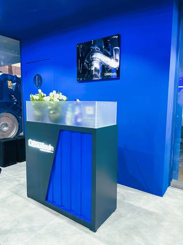 Outdoor exhibition stand in Dubai for Baudouin – bold design showcasing large industrial machines.