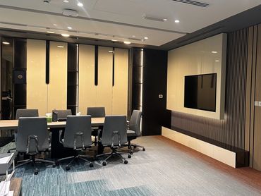 Corporate office interior design in Dubai with ergonomic furniture and glass partitions for a modern workspace.