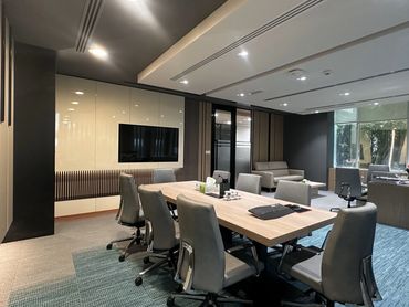 Corporate office interior design in Dubai with ergonomic furniture and glass partitions for a modern workspace.