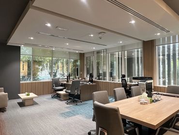Corporate office interior design in Dubai with ergonomic furniture and glass partitions for a modern workspace.